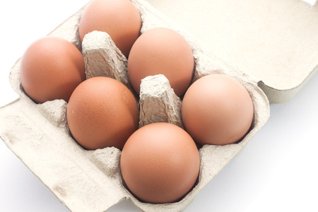 Brown eggs in packing for eggs isolated on white background
