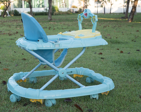 baby in the baby walker, plants backgroundの写真素材