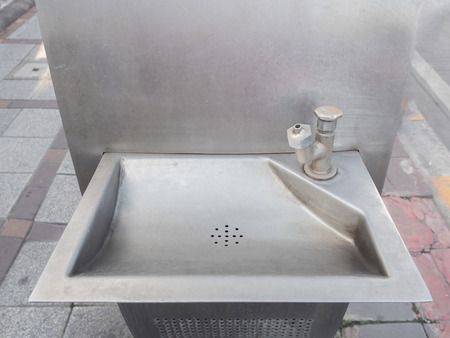 old faucet with sink in public park for drink.の写真素材