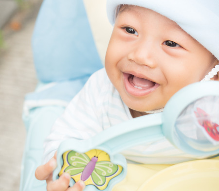 Baby boy smiling and showing his first teethの写真素材