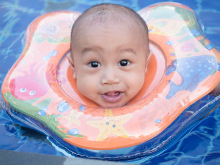little boy in the swimming pool in hot dayの写真素材
