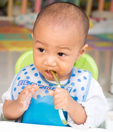 eating baby with spoonの写真素材