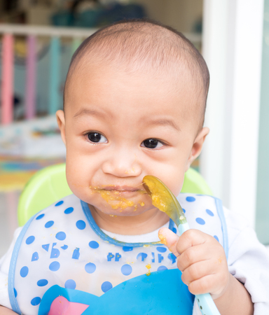 eating baby with spoonの写真素材