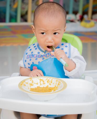 eating baby with spoonの写真素材