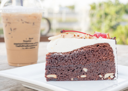 cake and ice coffee background on wood tableの写真素材