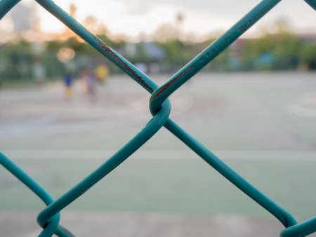 green wire fence in the basketball court