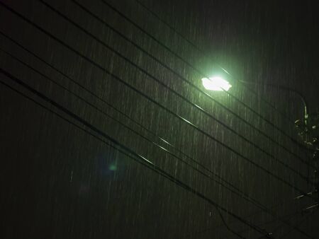 Night with light rain on the way homeの写真素材