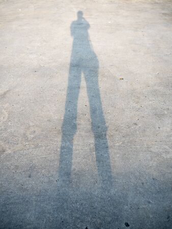 Tall human shadow on roadの写真素材
