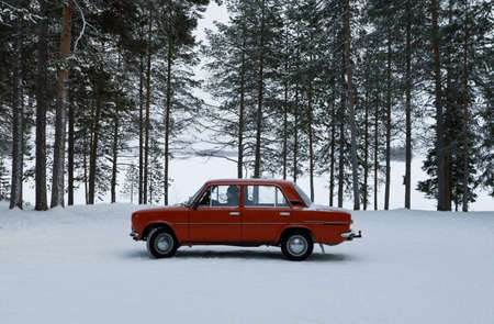 russian old red car on snowの写真素材