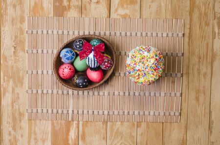 the ornamented eggs with Easter on a wooden table