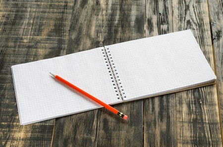 notebook with ball pen on a wooden tableの写真素材