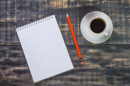 notebook with ball pen on a wooden tableの写真素材