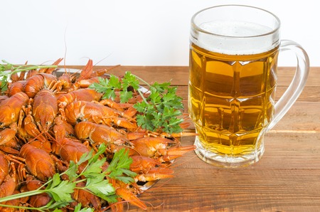 boiled crayfish with parsley on a wooden tableの写真素材
