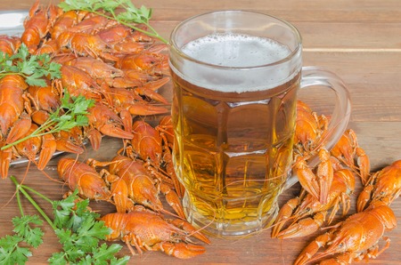 boiled crayfish with parsley on a wooden tableの写真素材