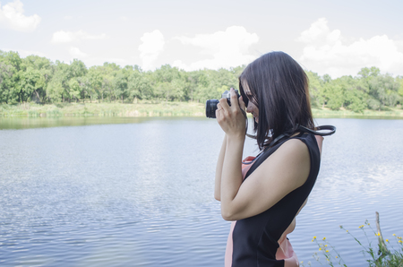 girl pictures of nature in the Sunny weather on the waterfrontの写真素材