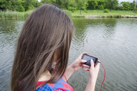girl with a telephone outside in a sunny dayの写真素材