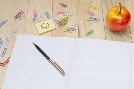 school supplies on a wooden school deskの写真素材