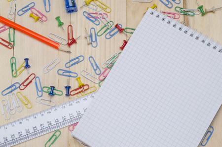 school supplies on a wooden school desk