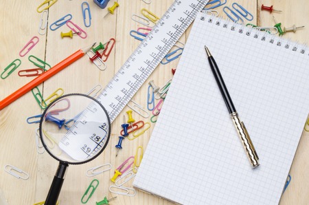 school supplies on a wooden school desk