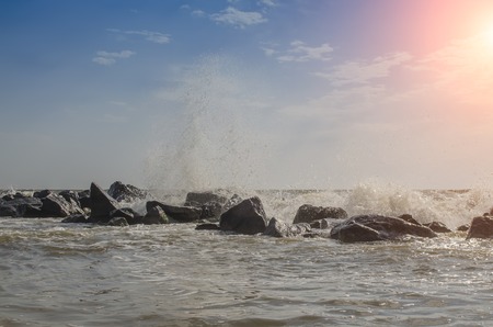sea waves hit about rocks into summertimeの写真素材