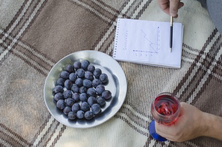 the young guy writes in a notebook in the open airの写真素材