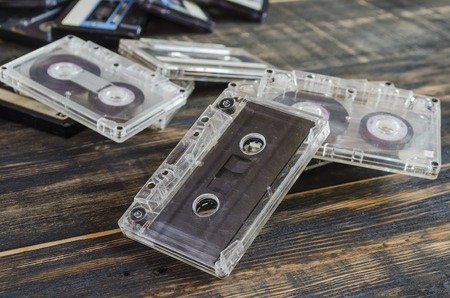 music on the old magnetic cartridge on a wooden tableの写真素材