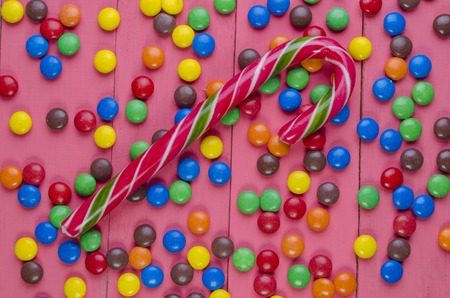 bright candies on a wooden pink tableの写真素材