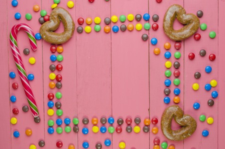 bright candies on a wooden pink tableの写真素材