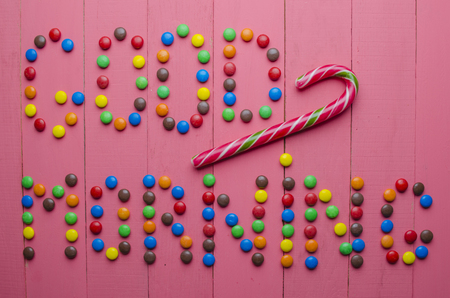 beautiful inscription from candies on a wooden pink backgroundの写真素材