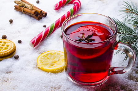 cup of hot mulled wine with seasonings on a tableの写真素材