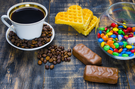 cup of hot coffee with grains and candiesの写真素材