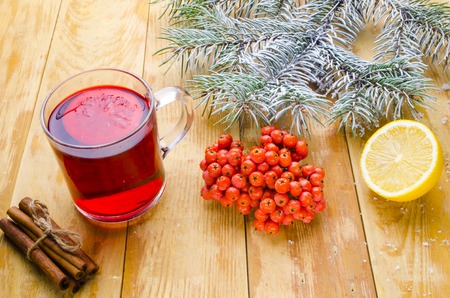 cup of hot mulled wine with seasonings on a tableの写真素材