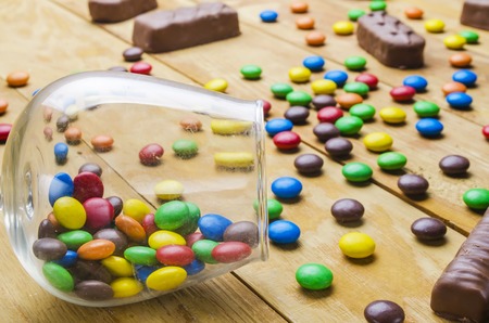 beautiful and bright candies on a wooden backgroundの写真素材