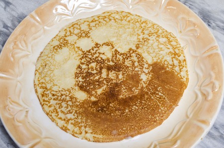 hot fried pancakes on a white plateの写真素材