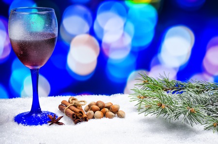 glass of hot wine with seasonings on a wooden tableの写真素材