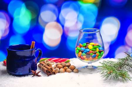 cup of hot tea with seasonings on snowの写真素材