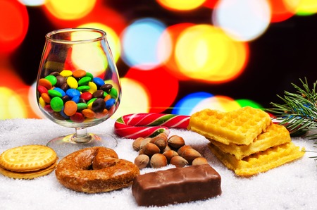 also cookies on snow are a lot of multi-colored chocolatesの写真素材