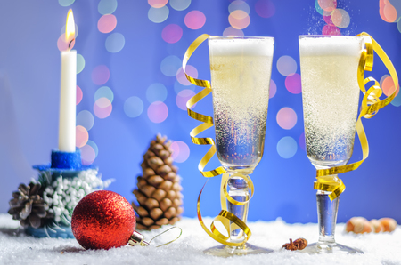 Two glasses of champagne on Christmas background with toysの写真素材