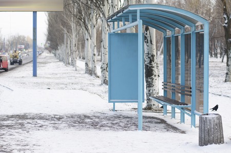 empty bus stop in the cold snowy weatherの写真素材
