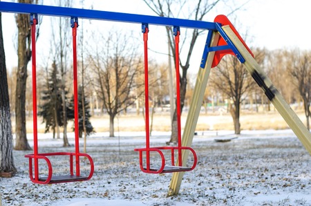children's playground on a cold winter day without childrenの写真素材