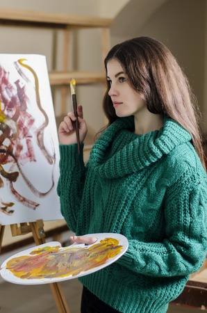 beautiful girl with a paintbrush in his handの写真素材