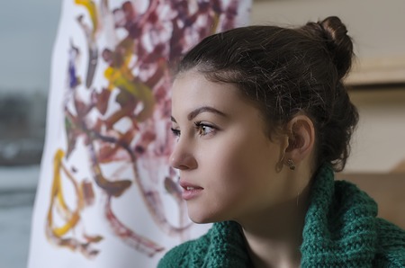 beautiful girl with a paintbrush in his handの写真素材