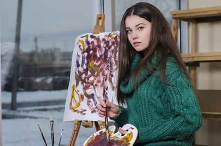 beautiful girl with a paintbrush in his handの写真素材