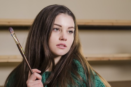 beautiful girl with a paintbrush in his handの写真素材