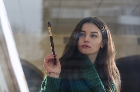 beautiful girl with a paintbrush in his handの写真素材