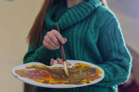 beautiful girl with a paintbrush in his handの写真素材