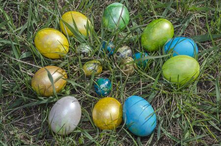 Easter handmade eggs lie on the green grass
