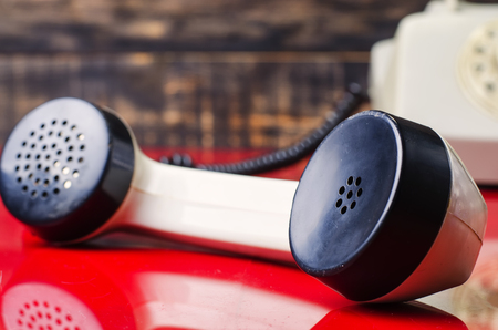 vintage white telephone with a round dial numbersの写真素材