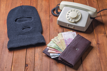 black mask on a table with a fixed telephoneの写真素材