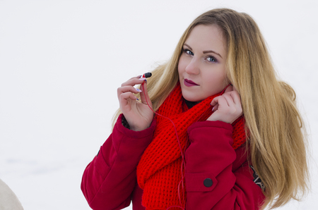 girl listening to music with headphones in the winterの写真素材